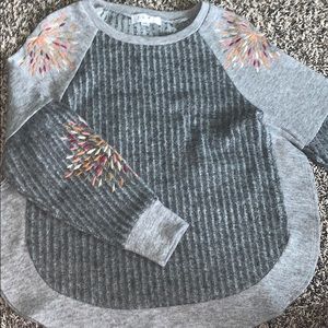 grey sweater with sleeve designs